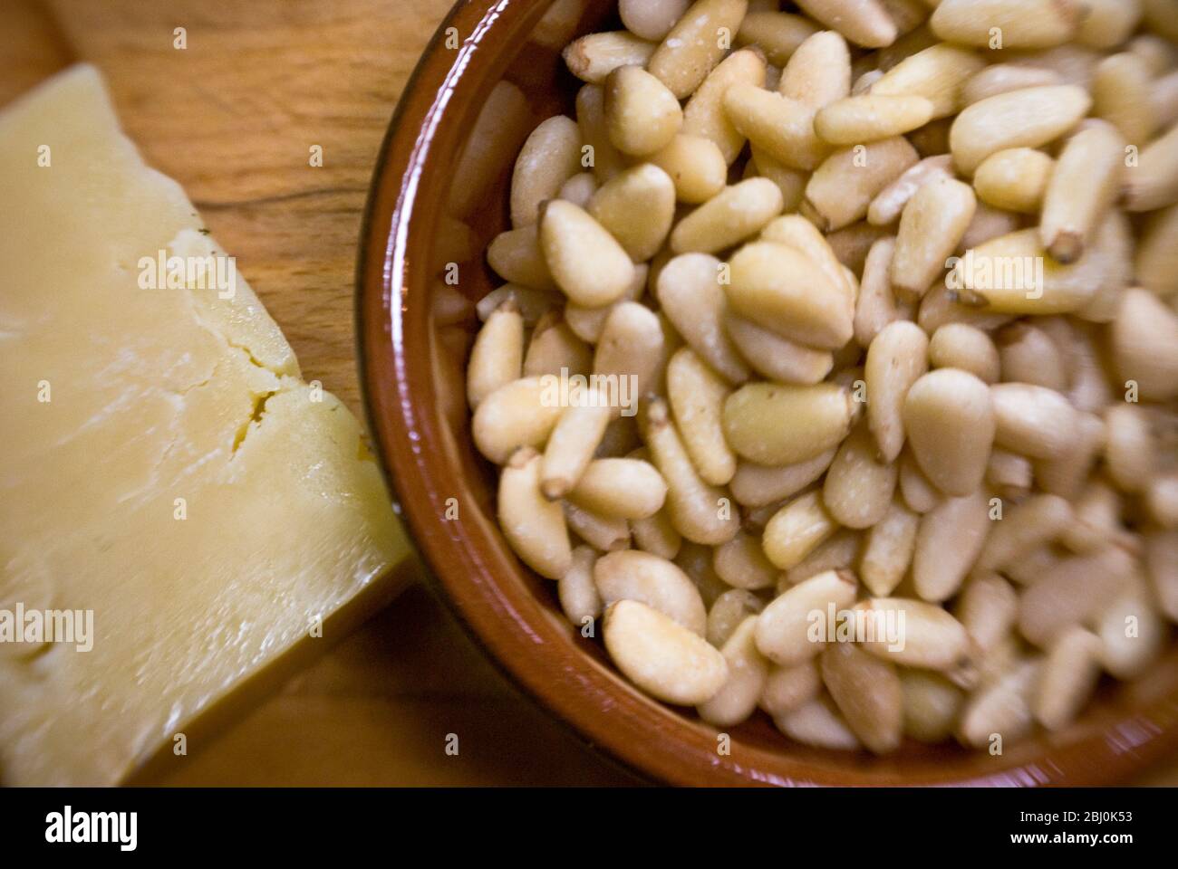 Pinenuts and mature cheese to make pesto - Stock Photo