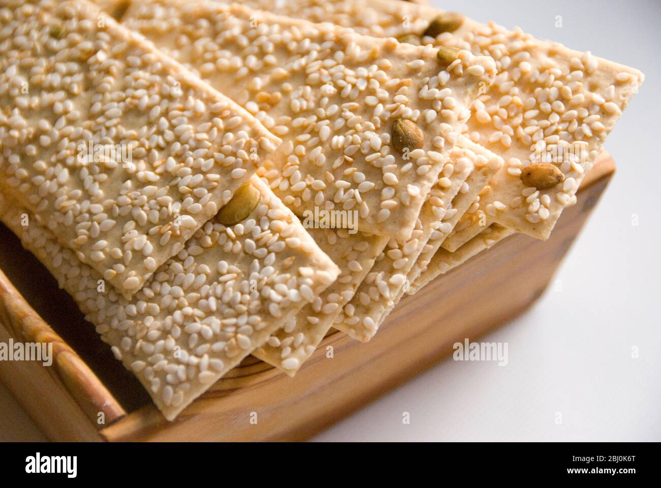 Pumpkin and sesame seeds flatbreads in wooden box - Stock Photo