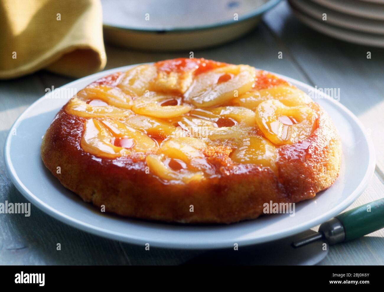 Upside down cake with pears and cherries - Stock Photo