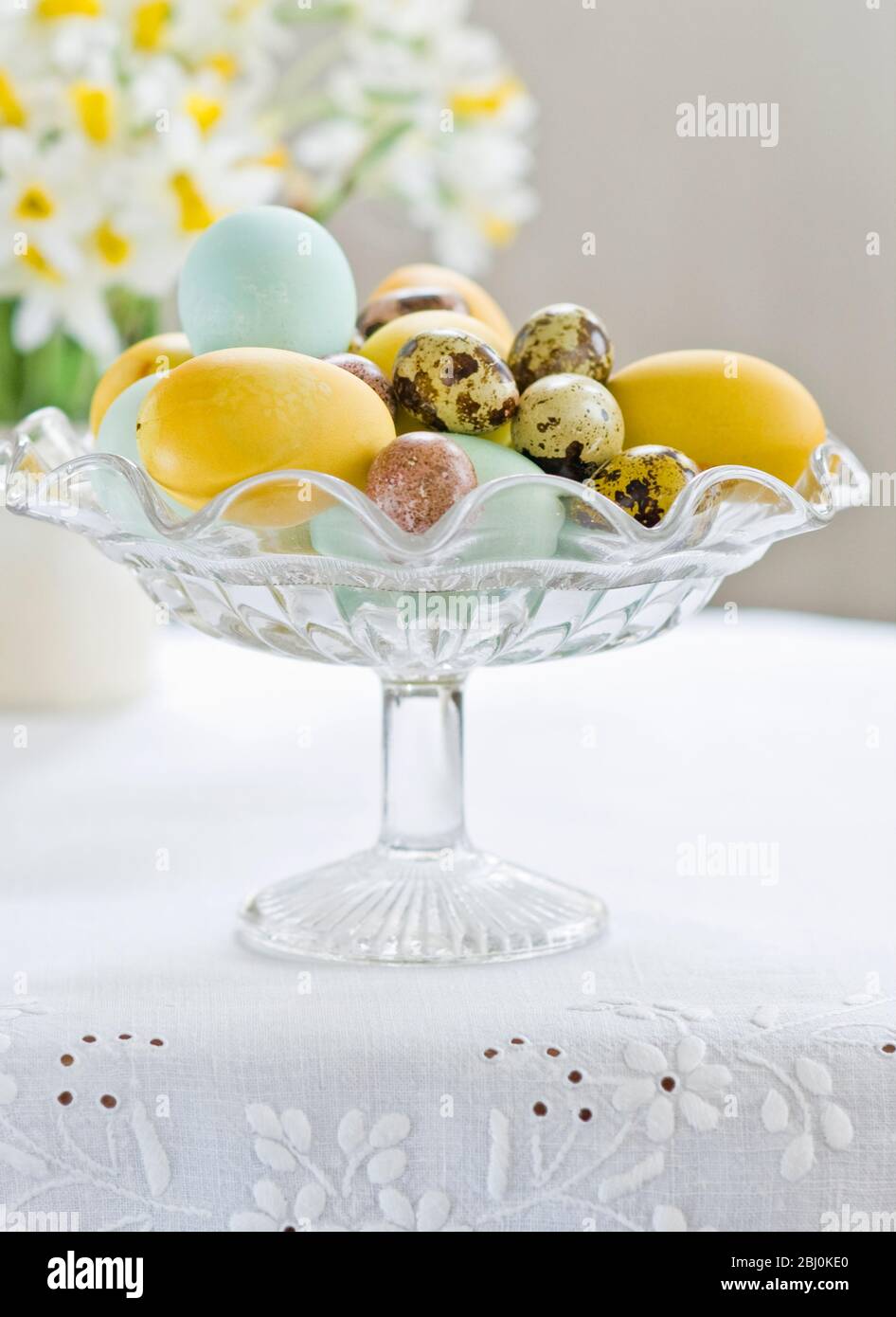 Glass stand with hand painted eggs including quais eggs - Stock Photo