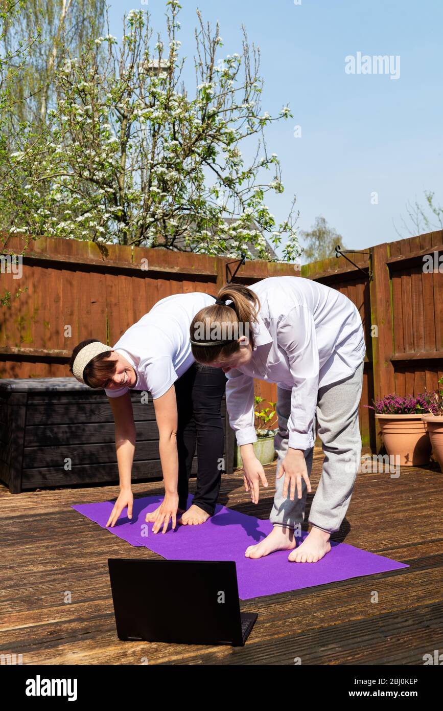 Happy Mother and Daughter are doing yoga Stock Photo
