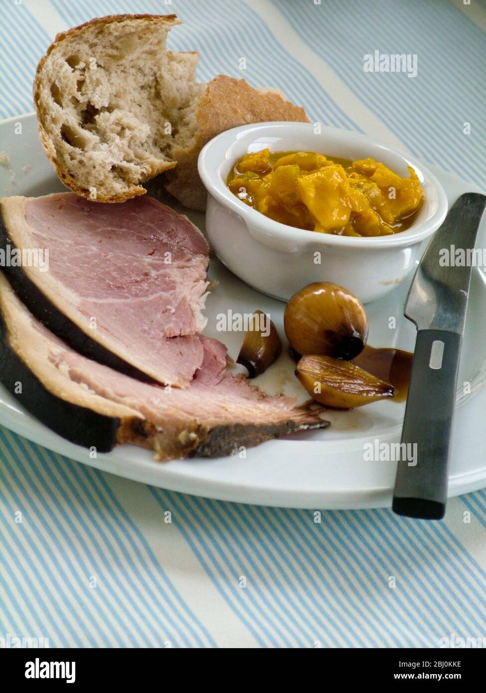 Smoked York ham with pickles and crusty bread - Stock Photo