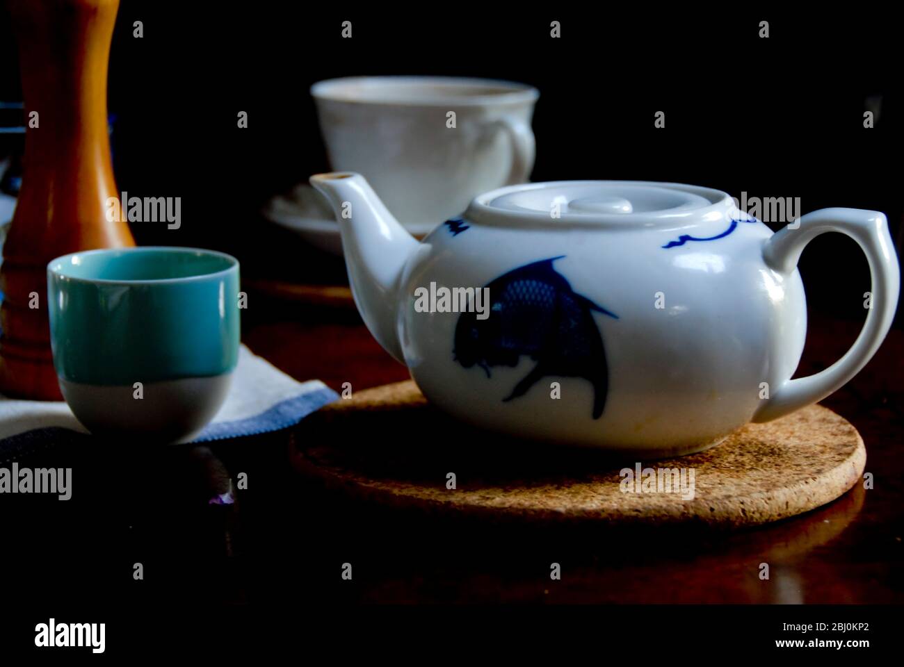 Chineses teapot with variety of tea cups - Stock Photo