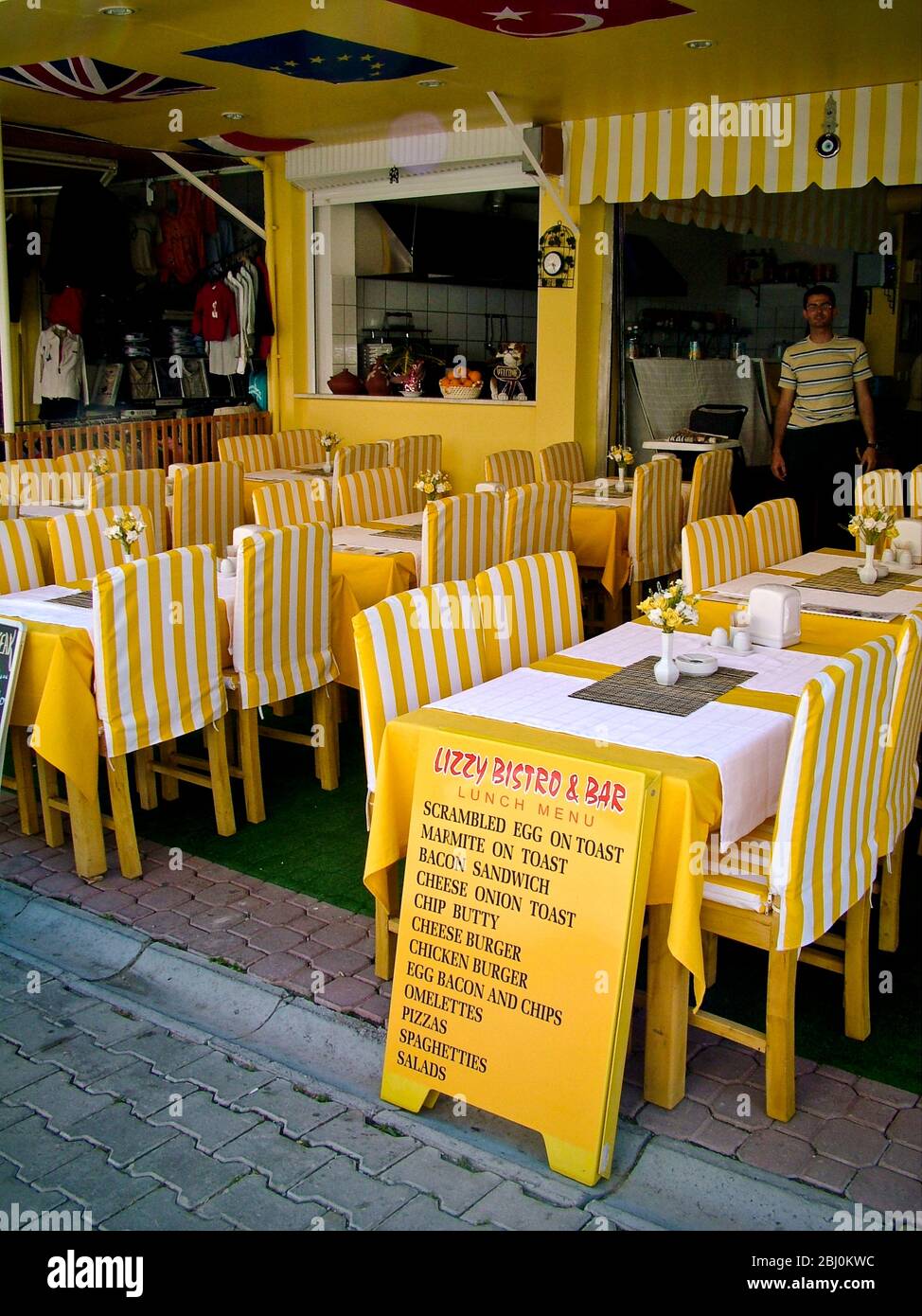 Smart yellow and white striped restaurant in Dalyan, southern Turkey - Stock Photo