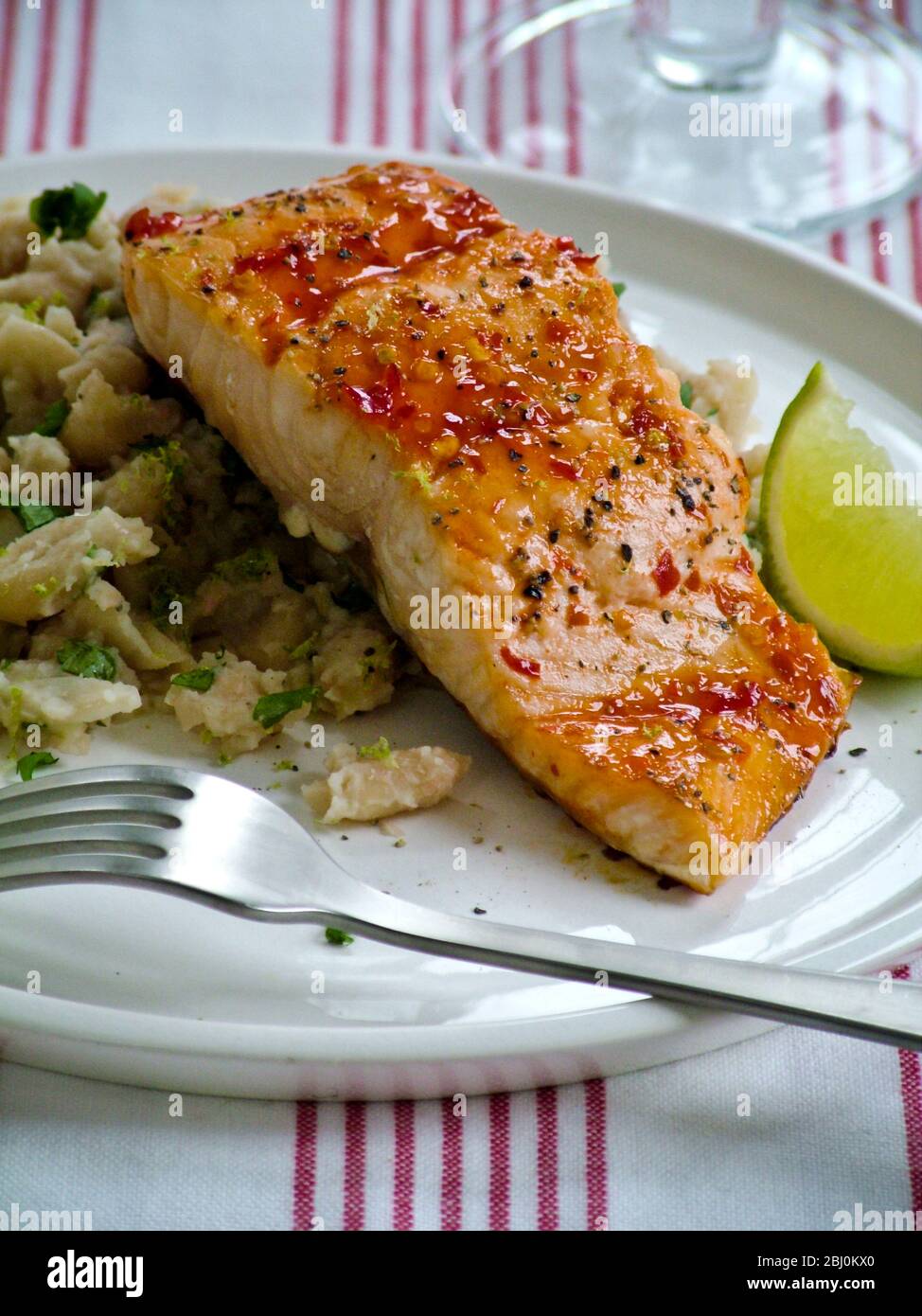 Spiced grill salmon fillet on rice pilaf with lime wedge Stock Photo Alamy