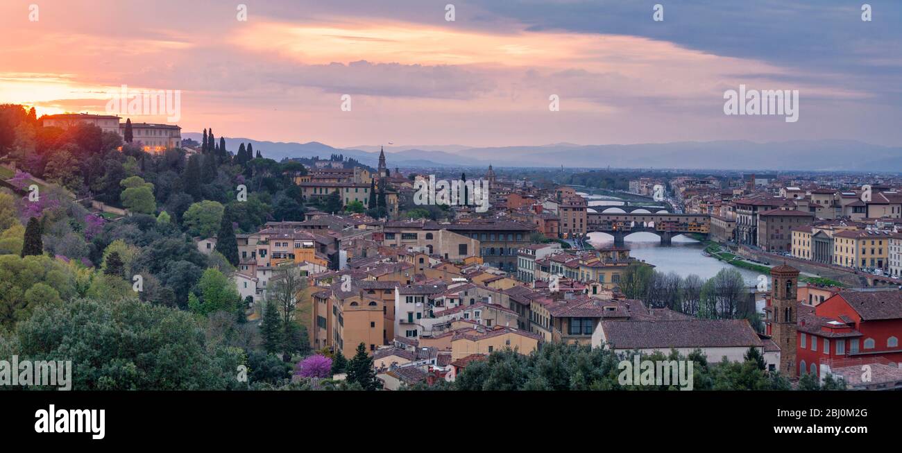 Panoramic view of Florence at sunset with in the background, the Basilica di Santo Spirito (English: Basilica of the Holy Spirit) and its spire, the C Stock Photo