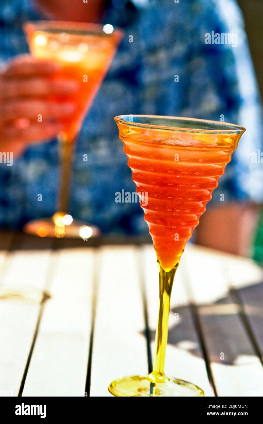 Brightly coloured fruity cocktails served oudoors - Stock Photo