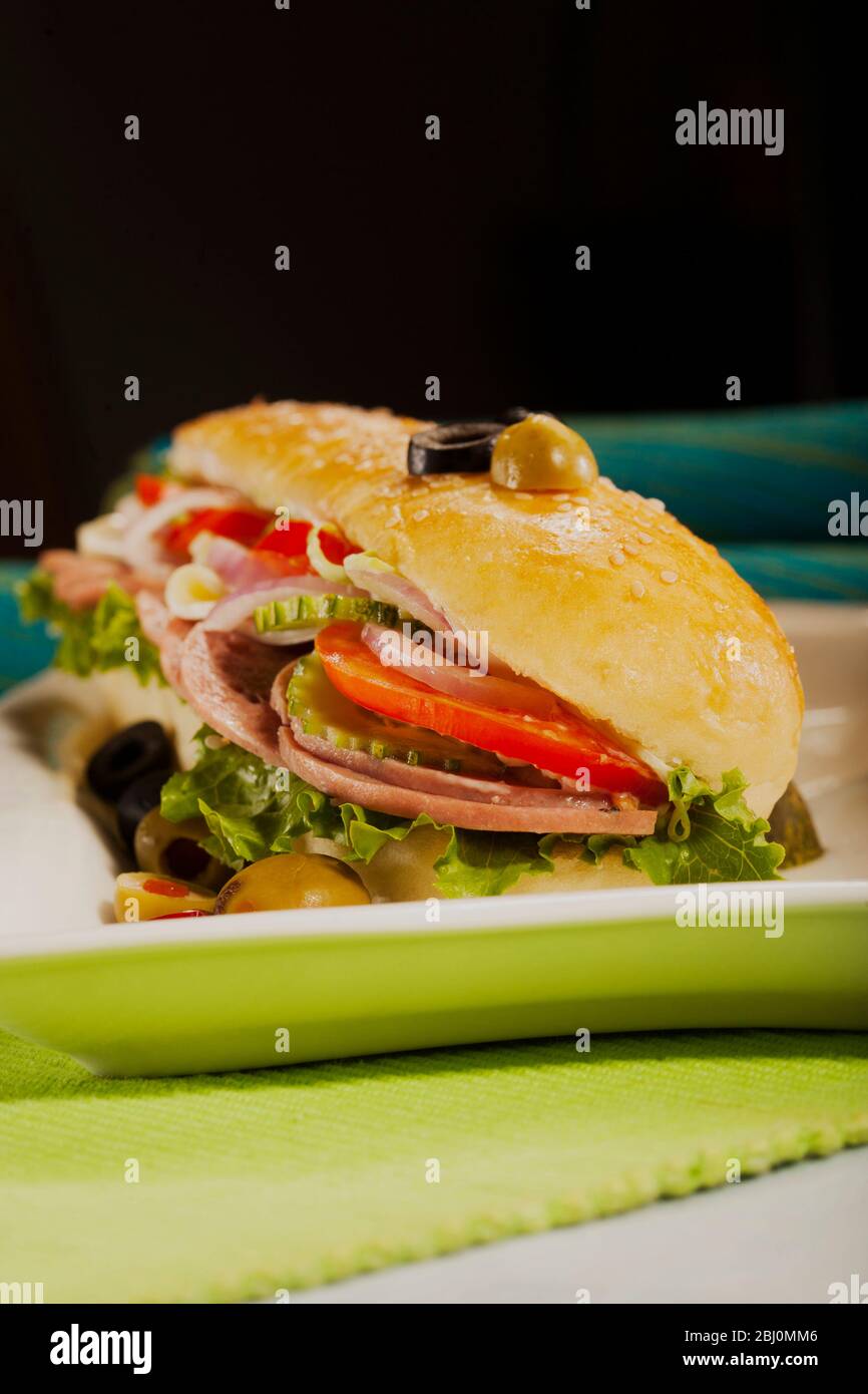Subs filled with veggies and meat kept on a white plate Stock Photo - Alamy