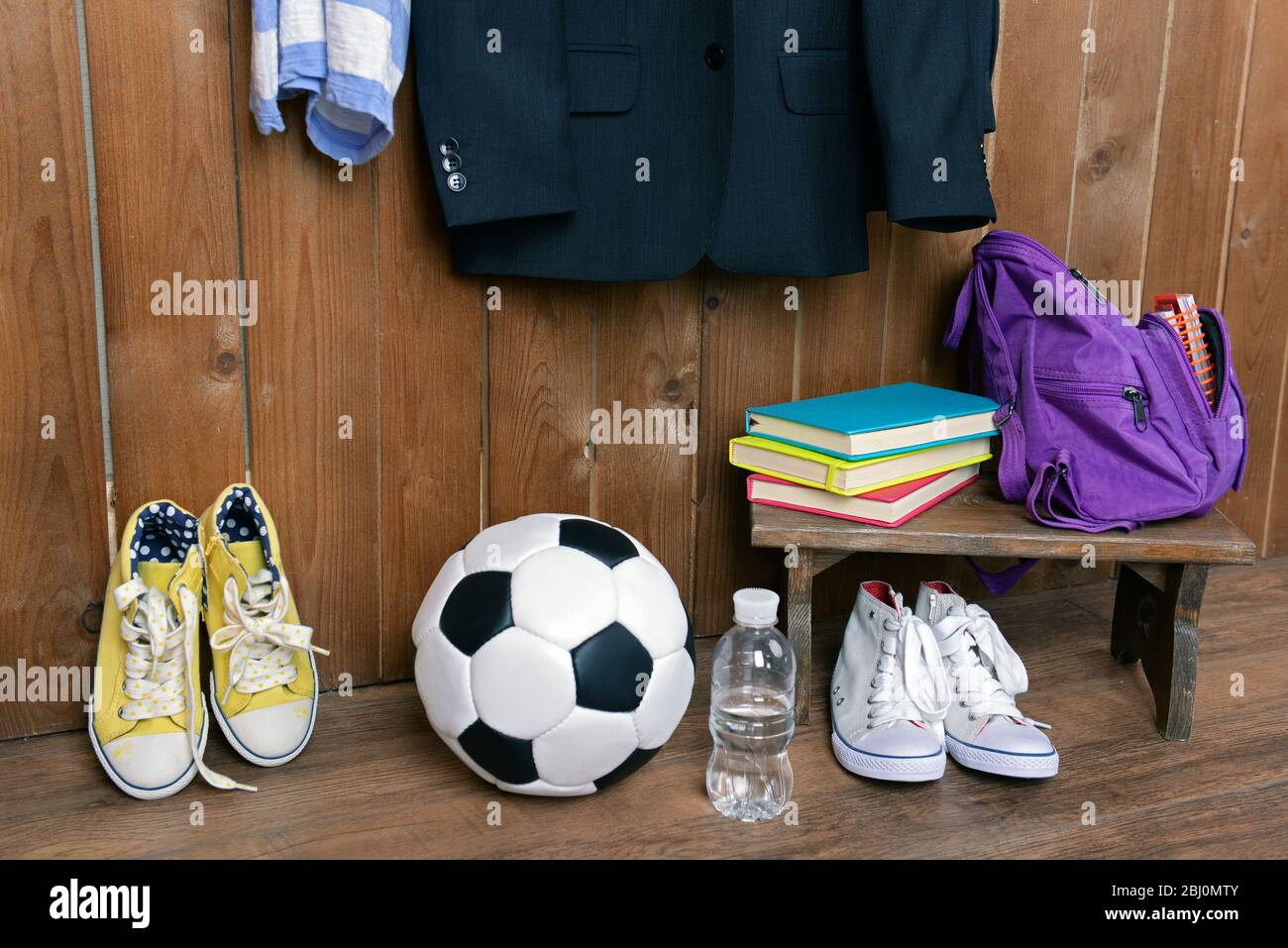 Children things hanging on wall and stacked in room Stock Photo - Alamy