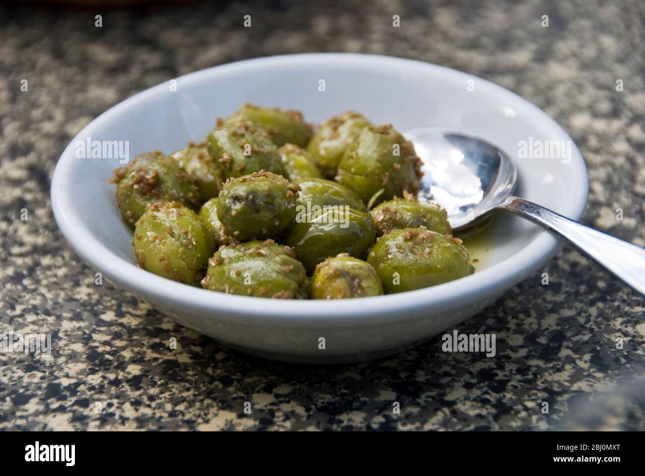 Small dish of olives served at tart of meze meal in Greek Cypriot village in southern Cyprus - Stock Photo