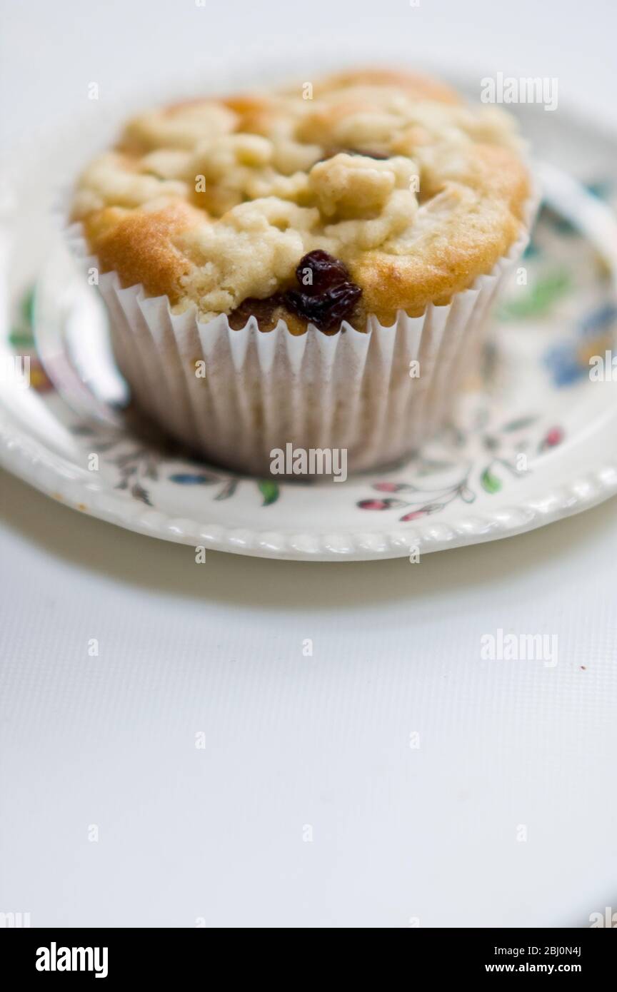 Small currant muffin topped with grated apple - Stock Photo