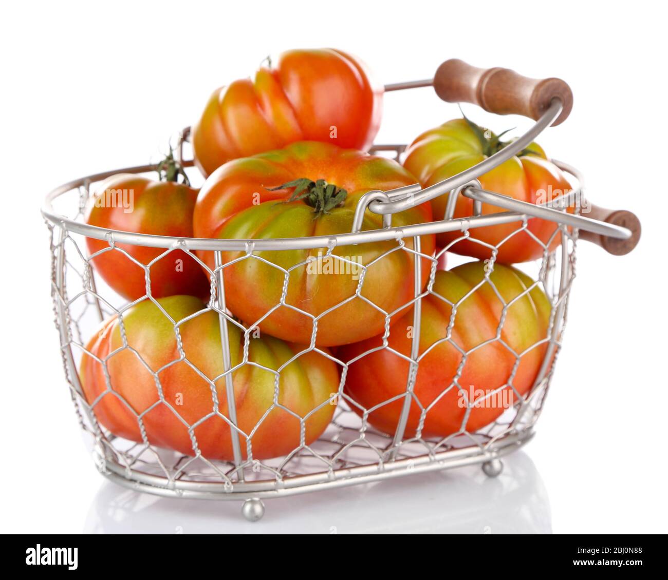 Green tomatoes in basket isolated on white Stock Photo - Alamy