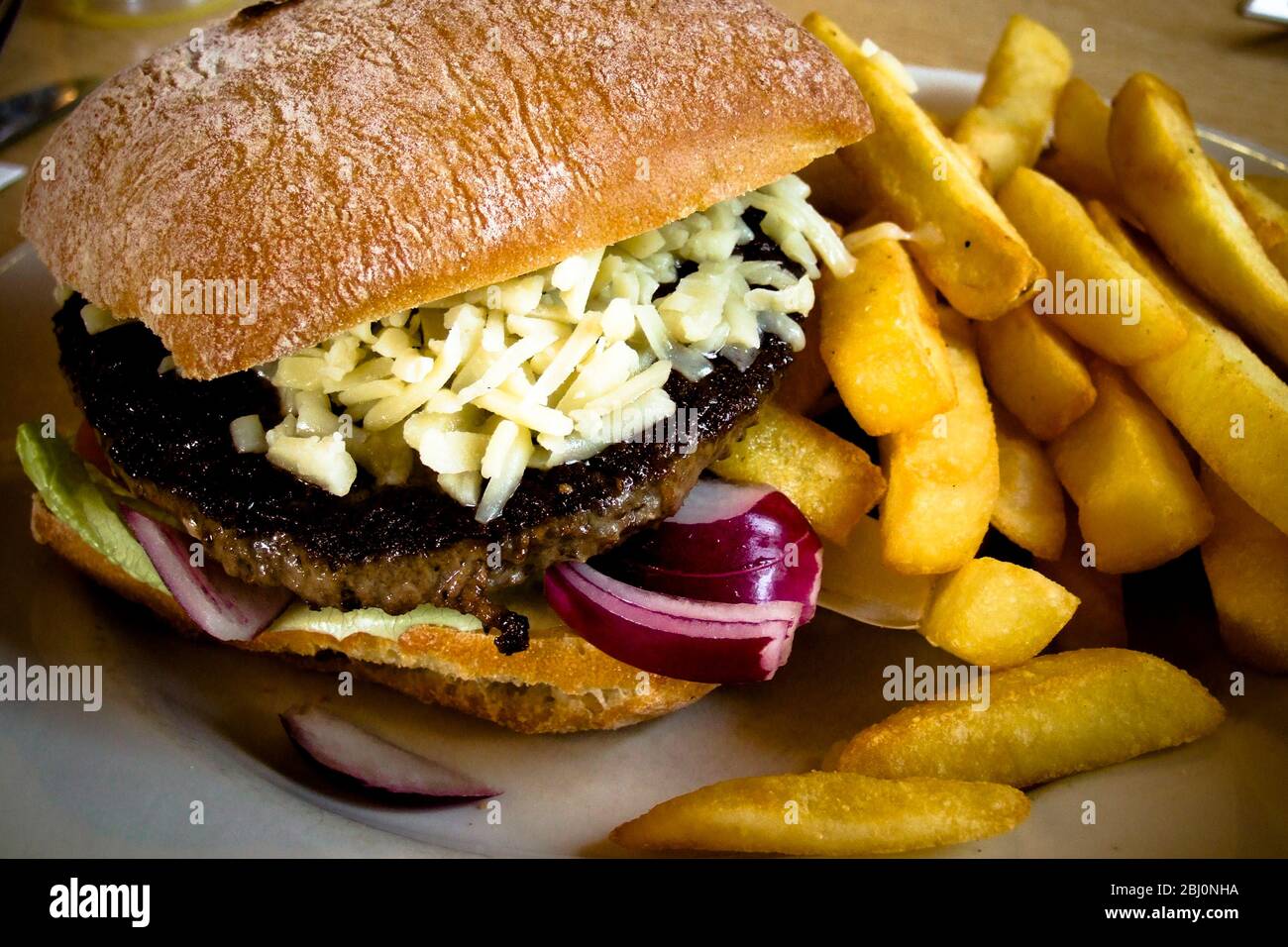 Burger and chips served at Little Chef. - Stock Photo