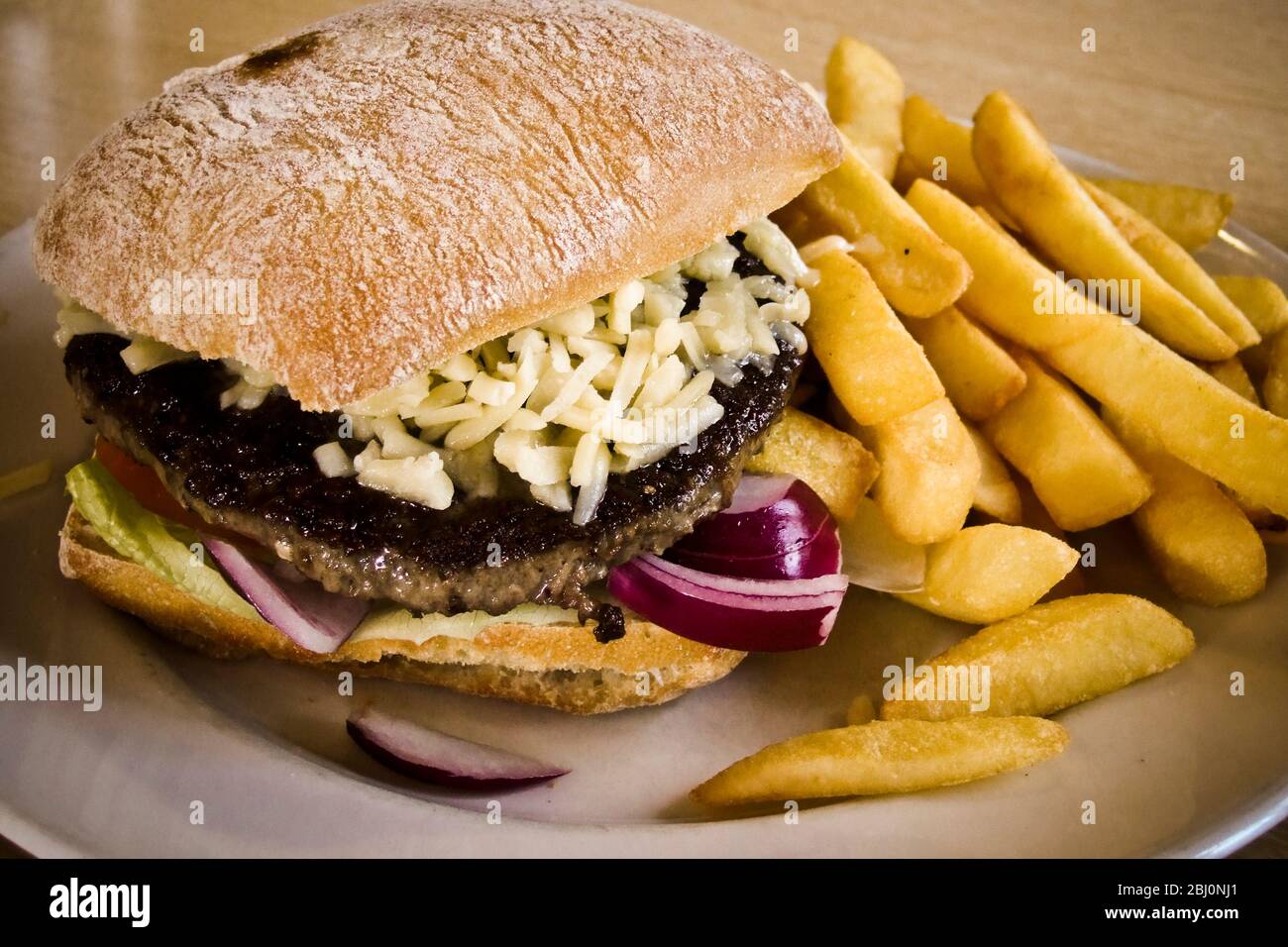 Burger and chips served at Little Chef. - Stock Photo