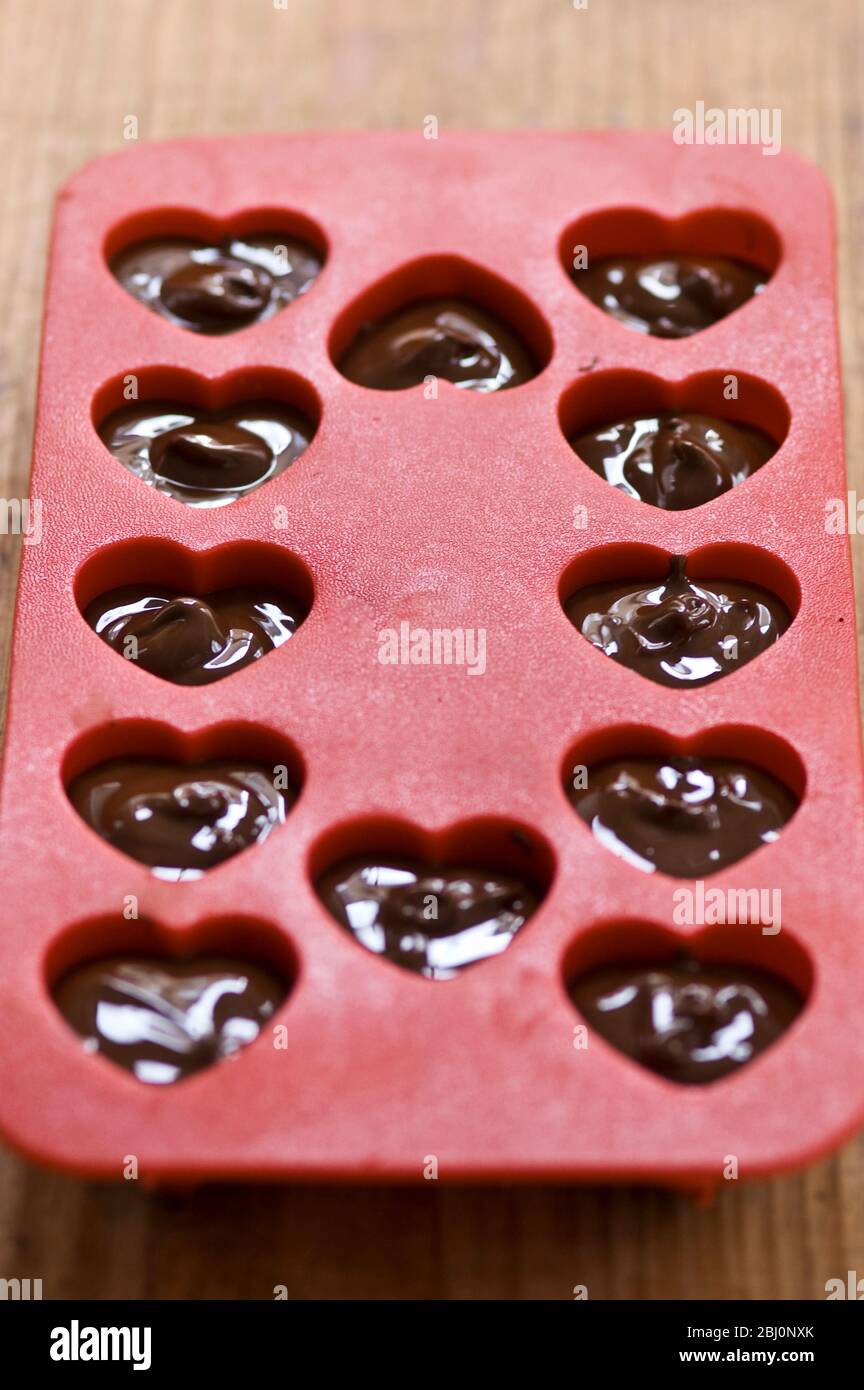 Making heart shaped in chocolates for Valentine's day in red heart