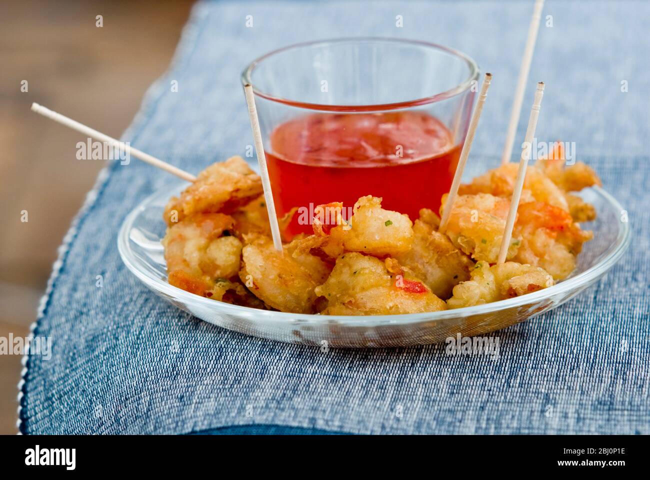 Small dish of Thai deep fried prawns with sweet dipping sauce - Stock Photo