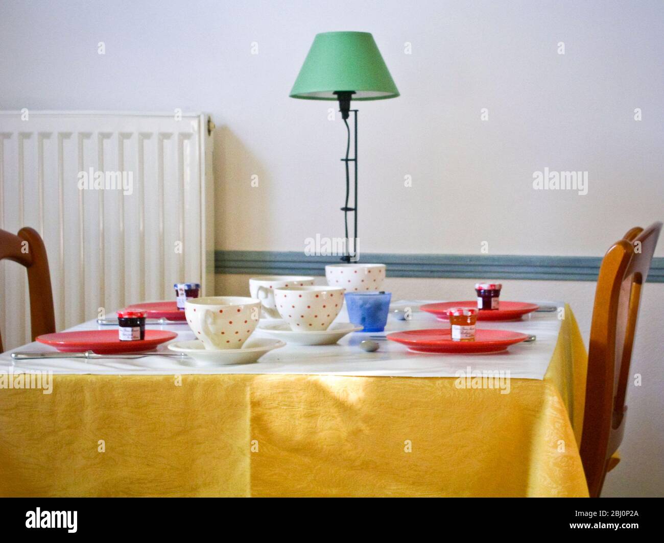 Interior. Dinging room of charming hotel in Rieumes, southern France, with tables set for breakfast - Stock Photo