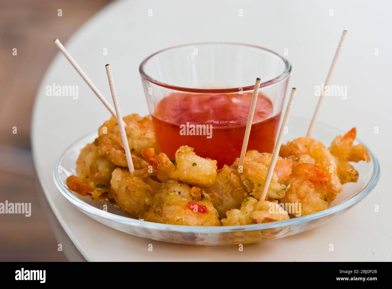 Small dish of Thai deep fried prawns with sweet dipping sauce - Stock Photo