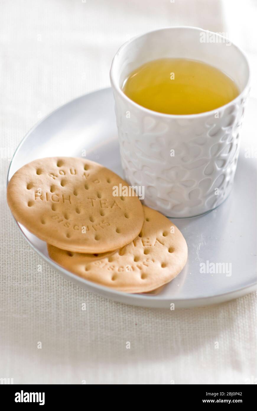 Light refreshment of herbal tea with plain biscuits - Stock Photo