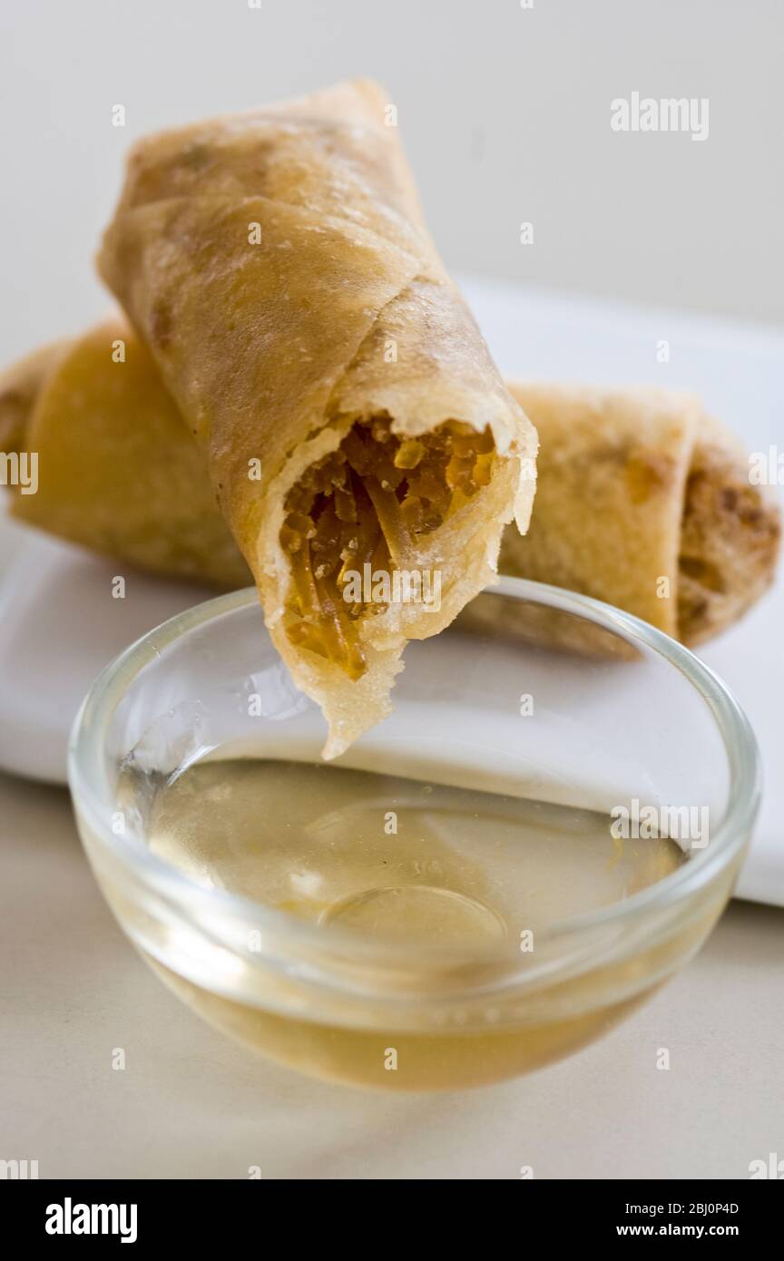 Small Thai spring rolls with sweet dipping sauce - Stock Photo