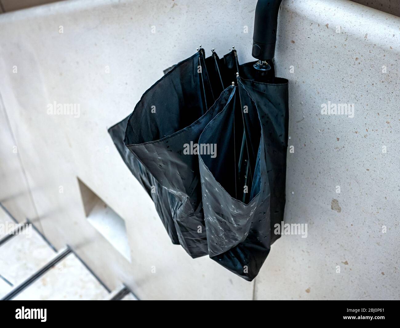 Umbrella hanging on wall Stock Photo