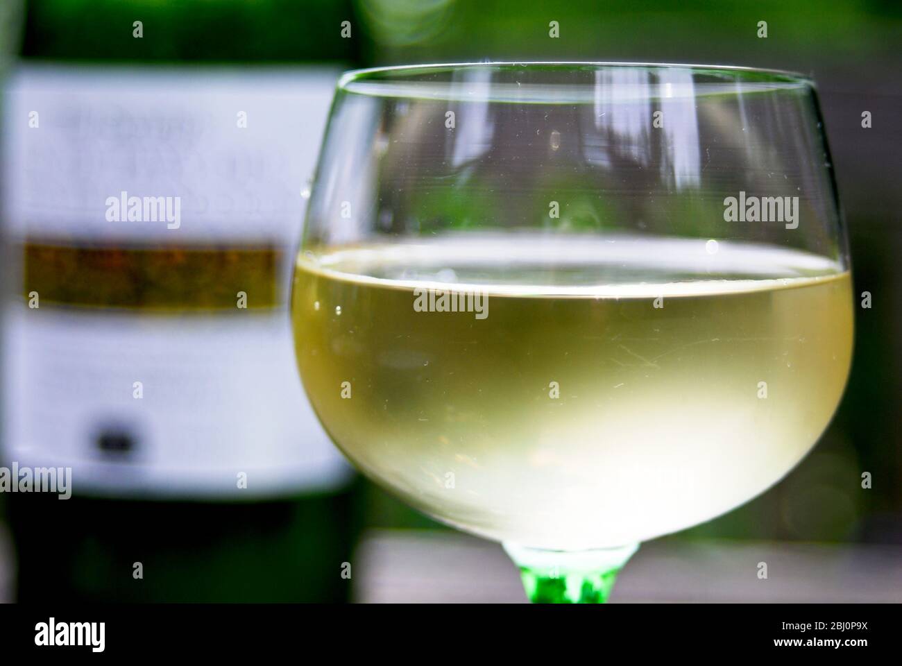 Chilled white wine in hock glass, outdoors on summer evening Stock