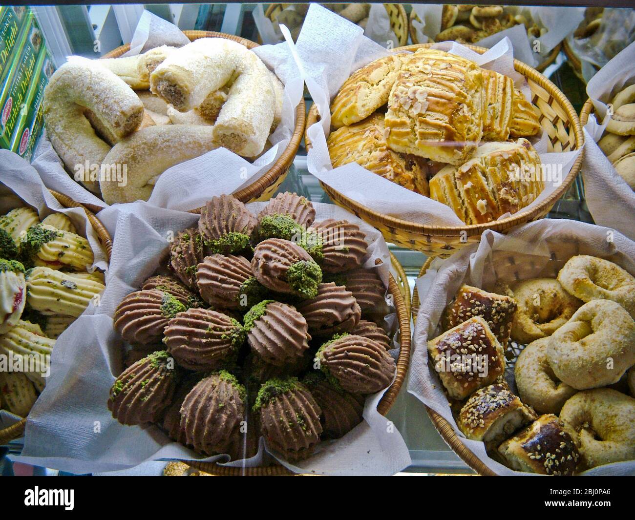 Selection of cakes, cookies and biscuits in display case of patisserie cafe in resort town of Dalayan, anatolia, Turkey - Stock Photo