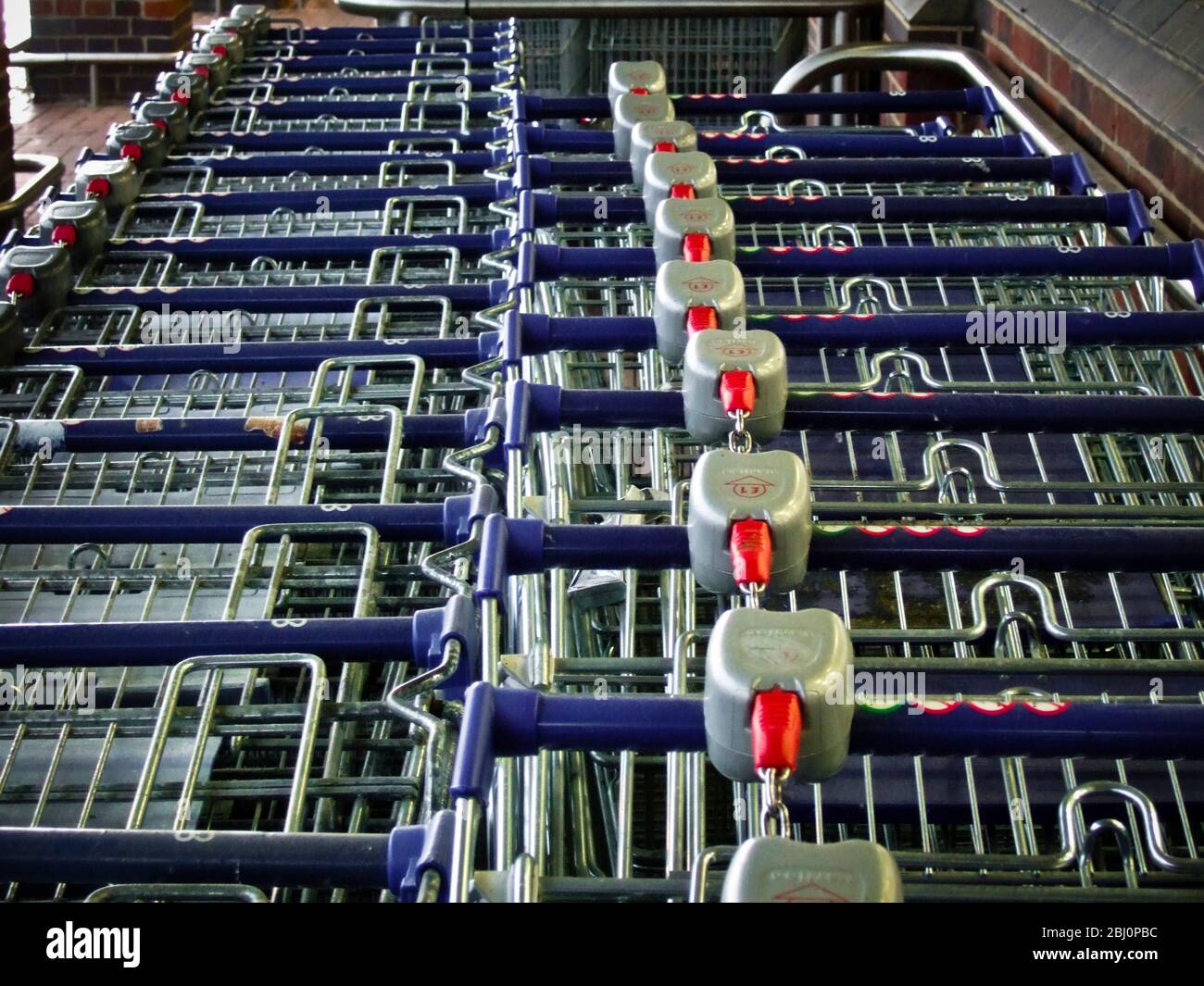 Supermarket trolleys pushed into each other outside. - Stock Photo