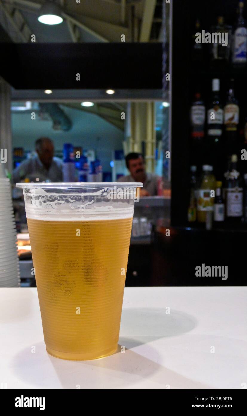 Larnaca Airport, Cyprus. Bar with plastic glass of Keo beer - Stock Photo