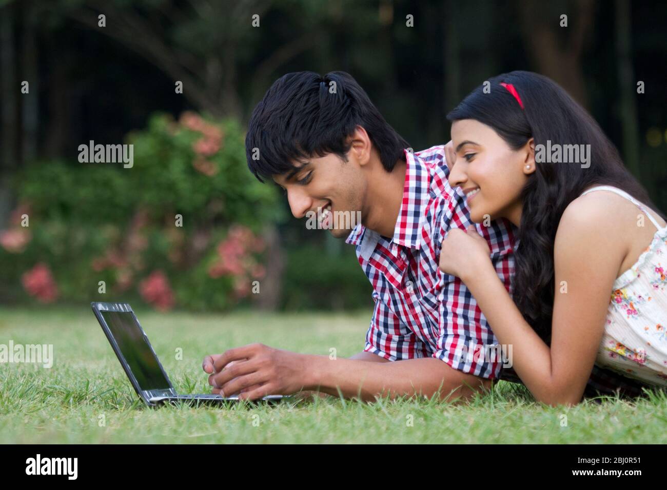 Man Woman Laptop Smiling Lying Happiness Grass Two People High Resolution Stock Photography And Images Alamy