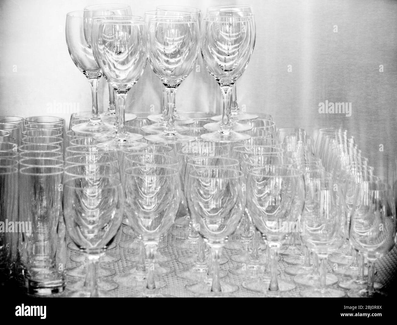 Stacked wine glasses in restaurant. Black & white - Stock Photo