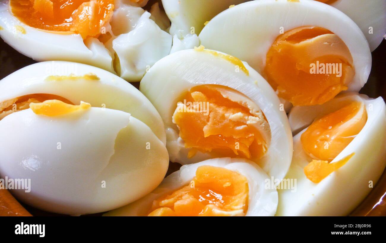 Detail of halved boiled eggs as part of a summer salad - Stock Photo