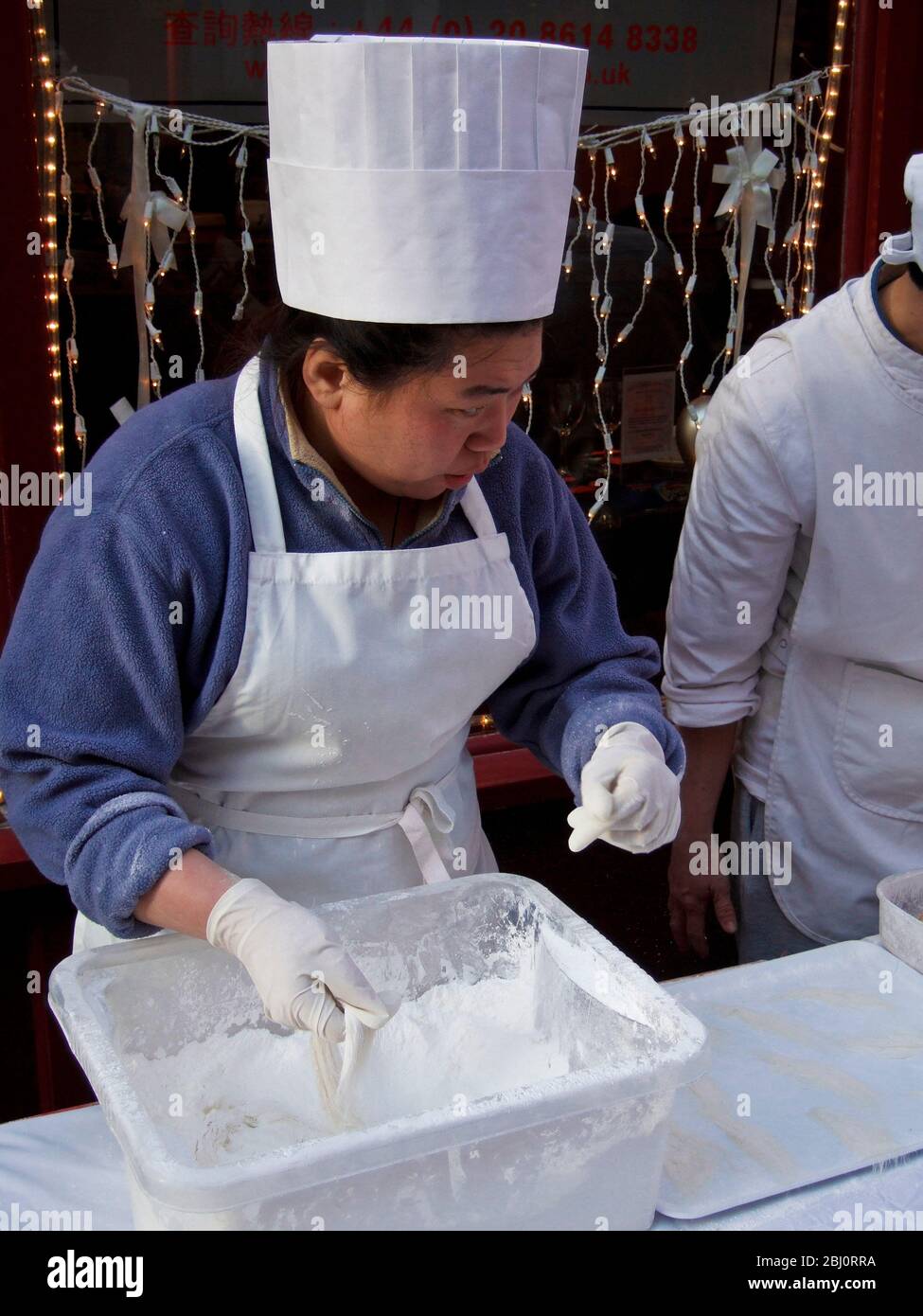 Dragon's Beard Candy being prepared in London's Chinatown for the Chinese New Year celebrations - Stock Photo