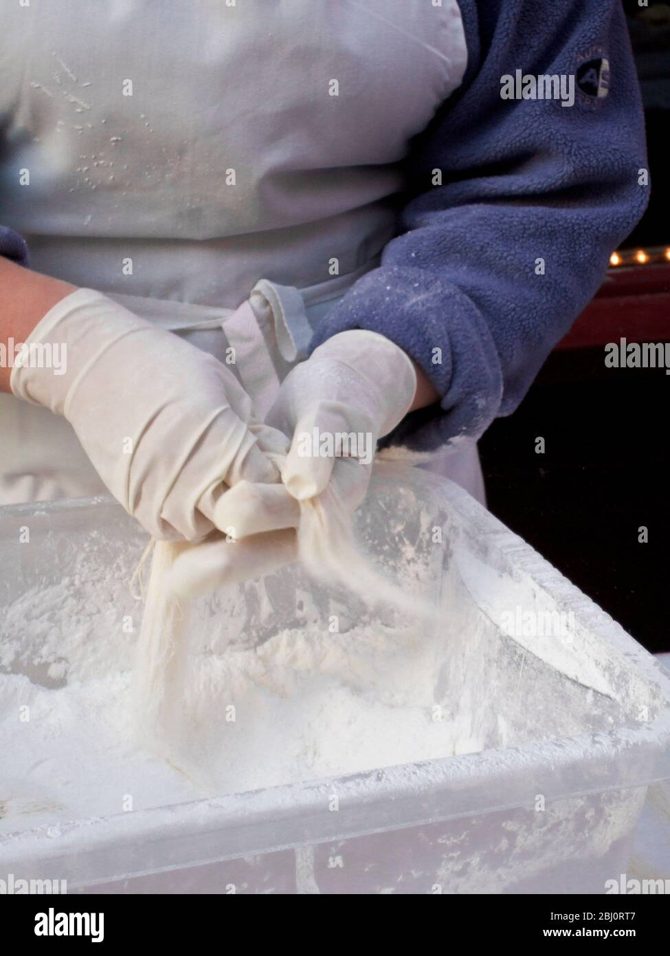 Dragon's Beard Candy being prepared in London's Chinatown for the Chinese New Year celebrations - Stock Photo