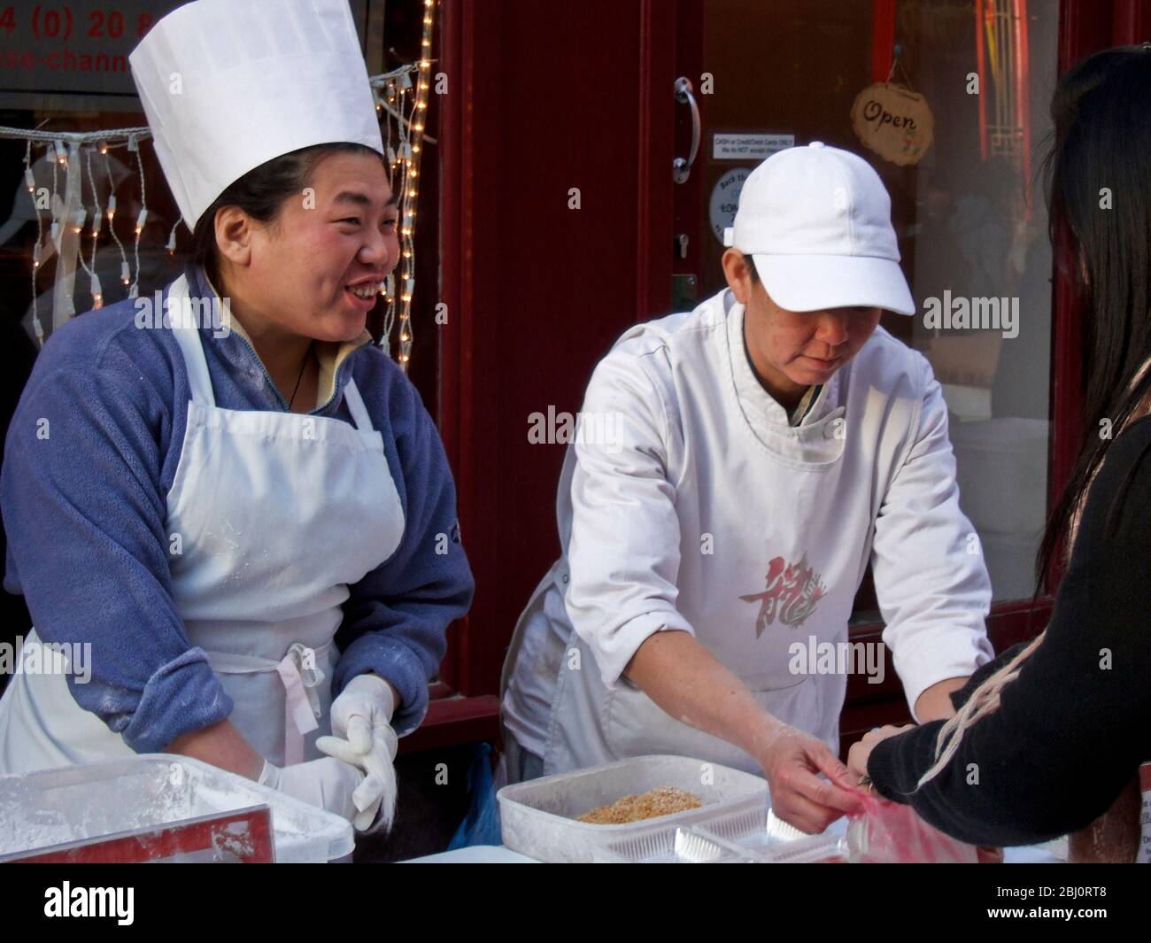 Dragon's Beard Candy being prepared in London's Chinatown for the Chinese New Year celebrations - Stock Photo