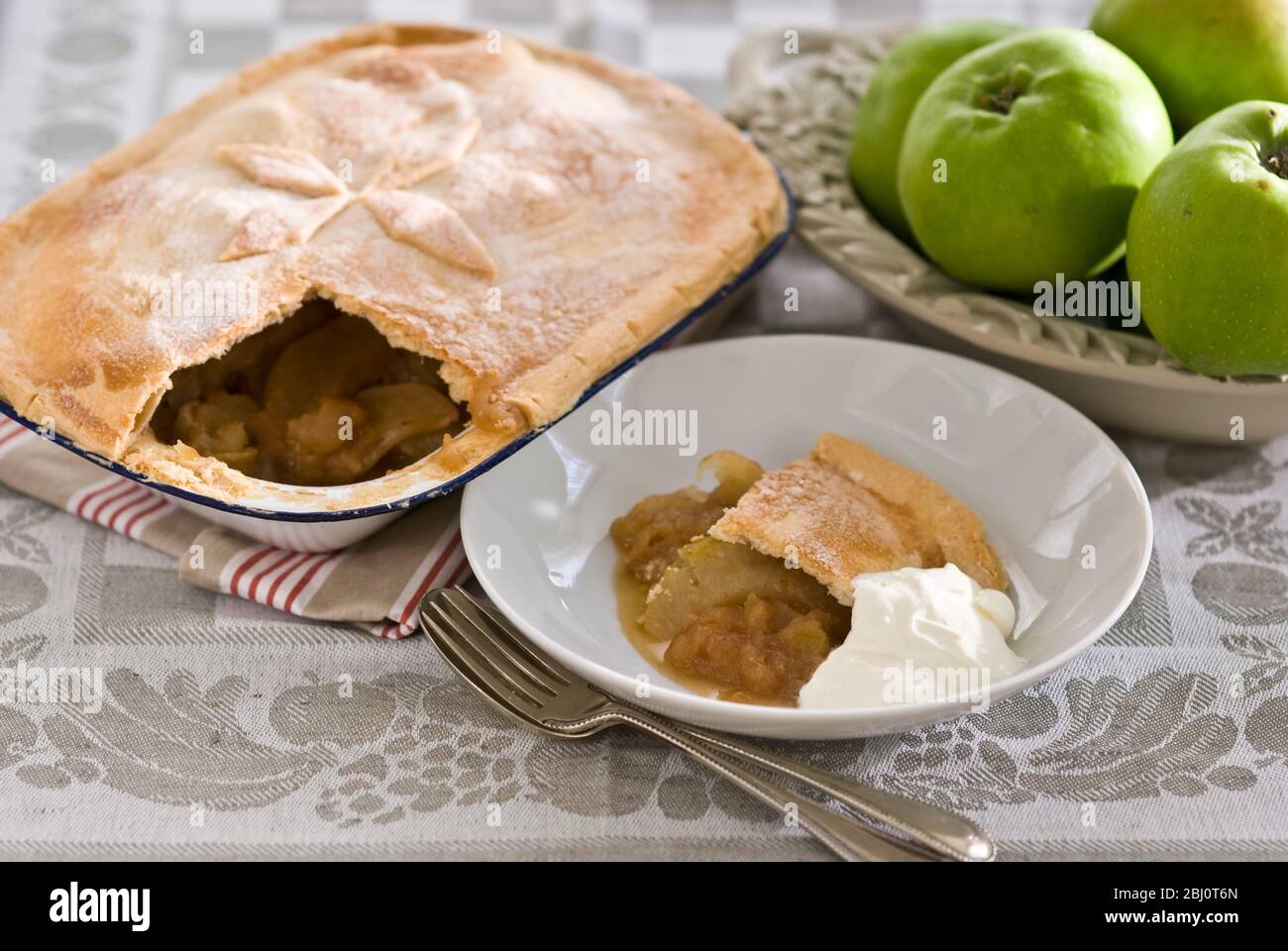Classic country style apple pie with cream - Stock Photo