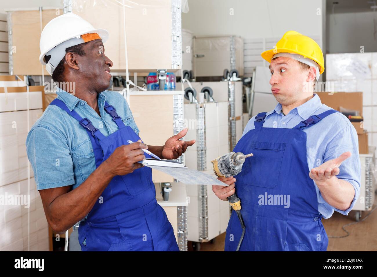 Professional male contractors discussing while determining scope of building work indoors Stock Photo