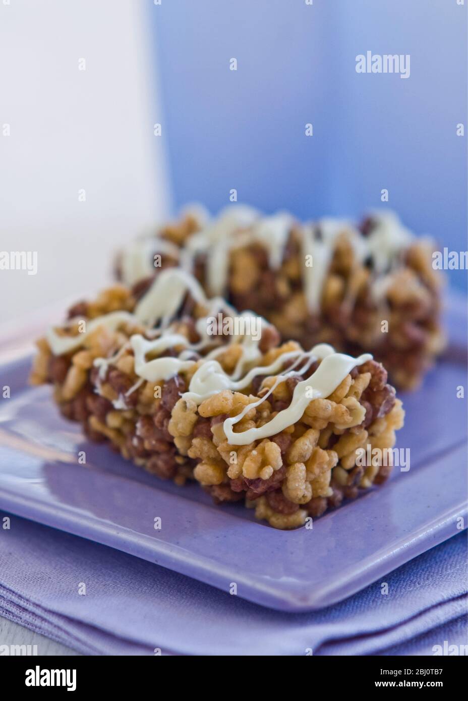 Chewy rice crispie bars with vanilla icing - Stock Photo