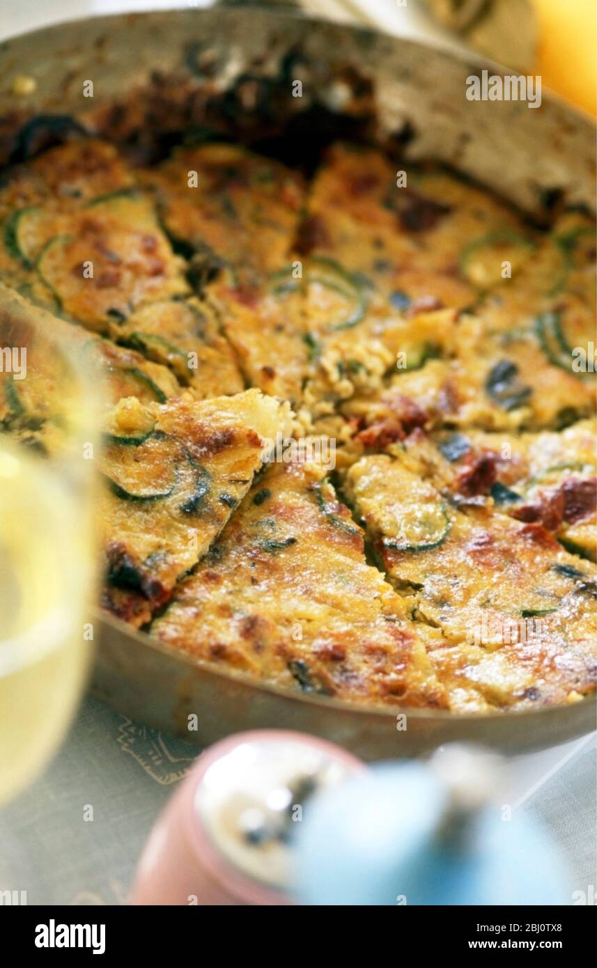 Frittata of courgettes and bacon served in frying pan Stock Photo Alamy