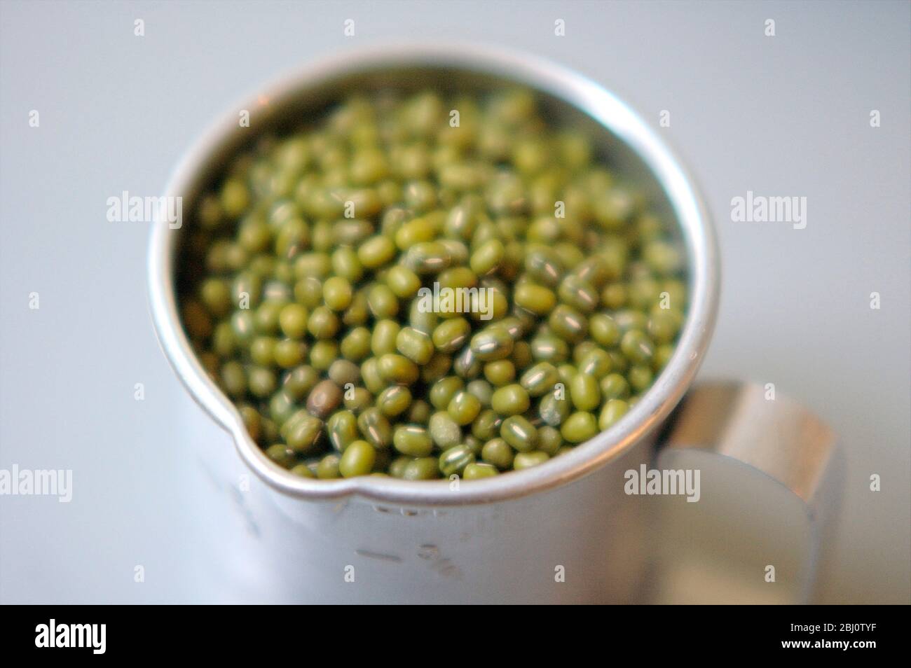 Mung beans in American cup measure - Stock Photo