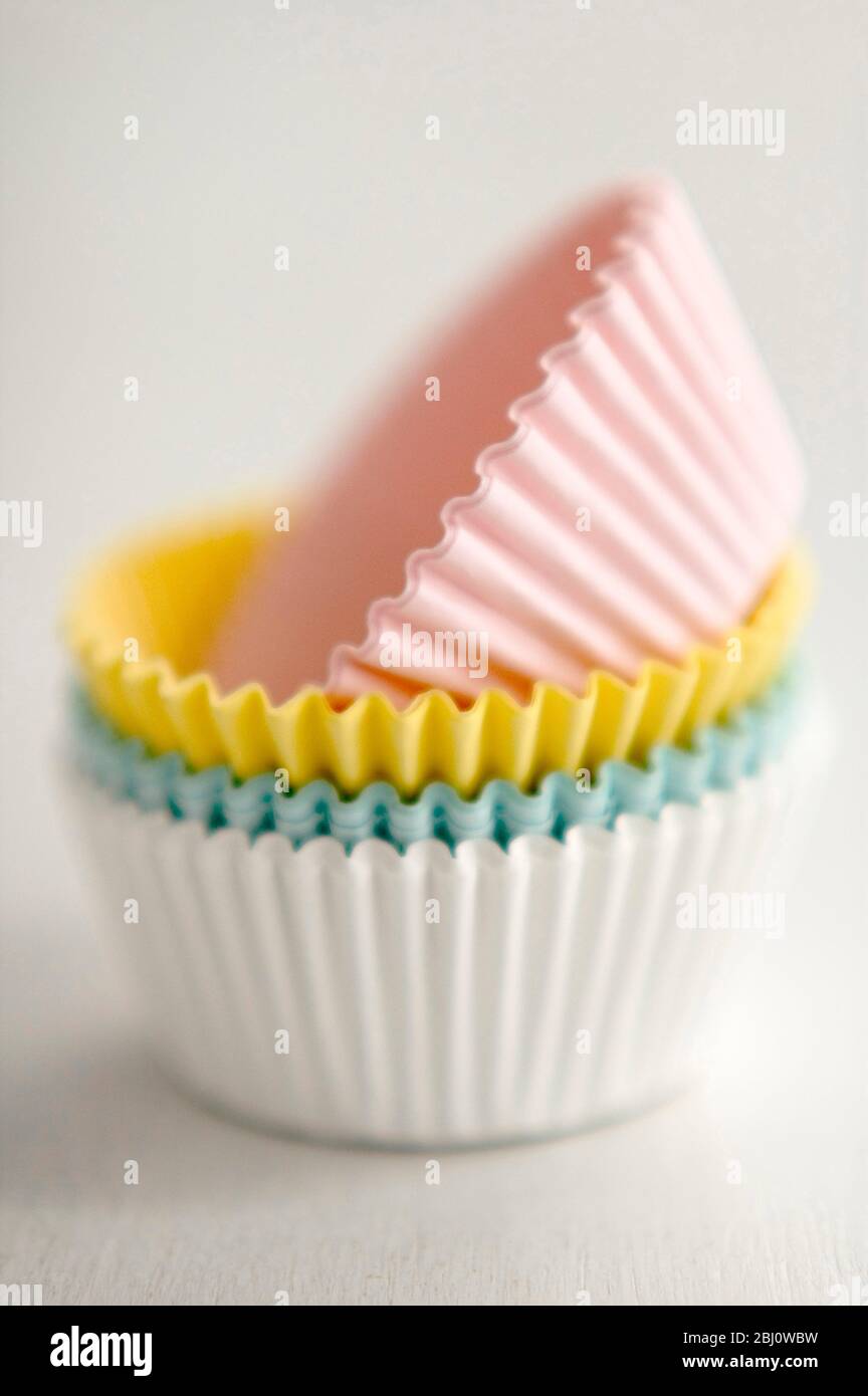 Stack of pastel coloured muffins cases - Stock Photo