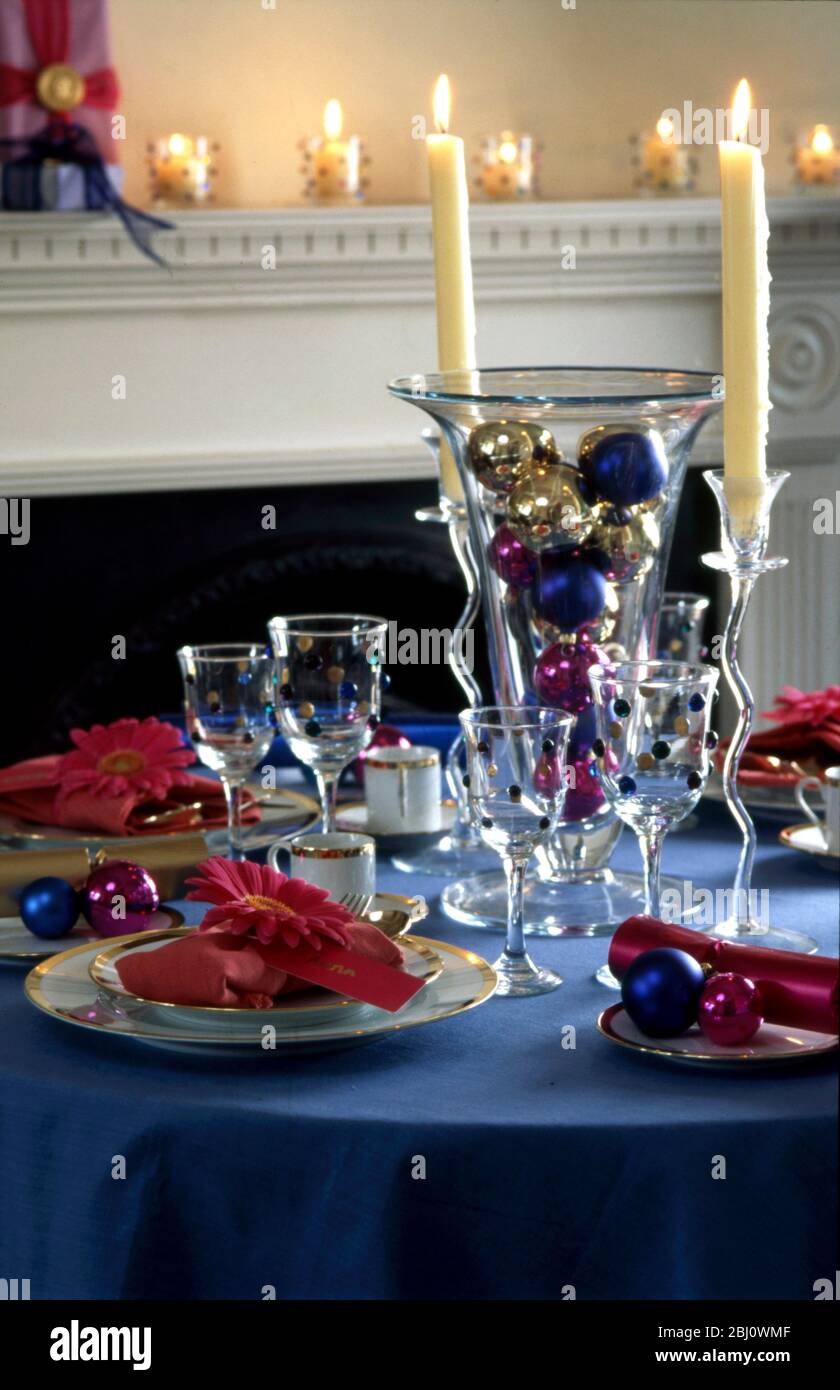 Festive table with decorated glass and christmas baubles - Stock Photo