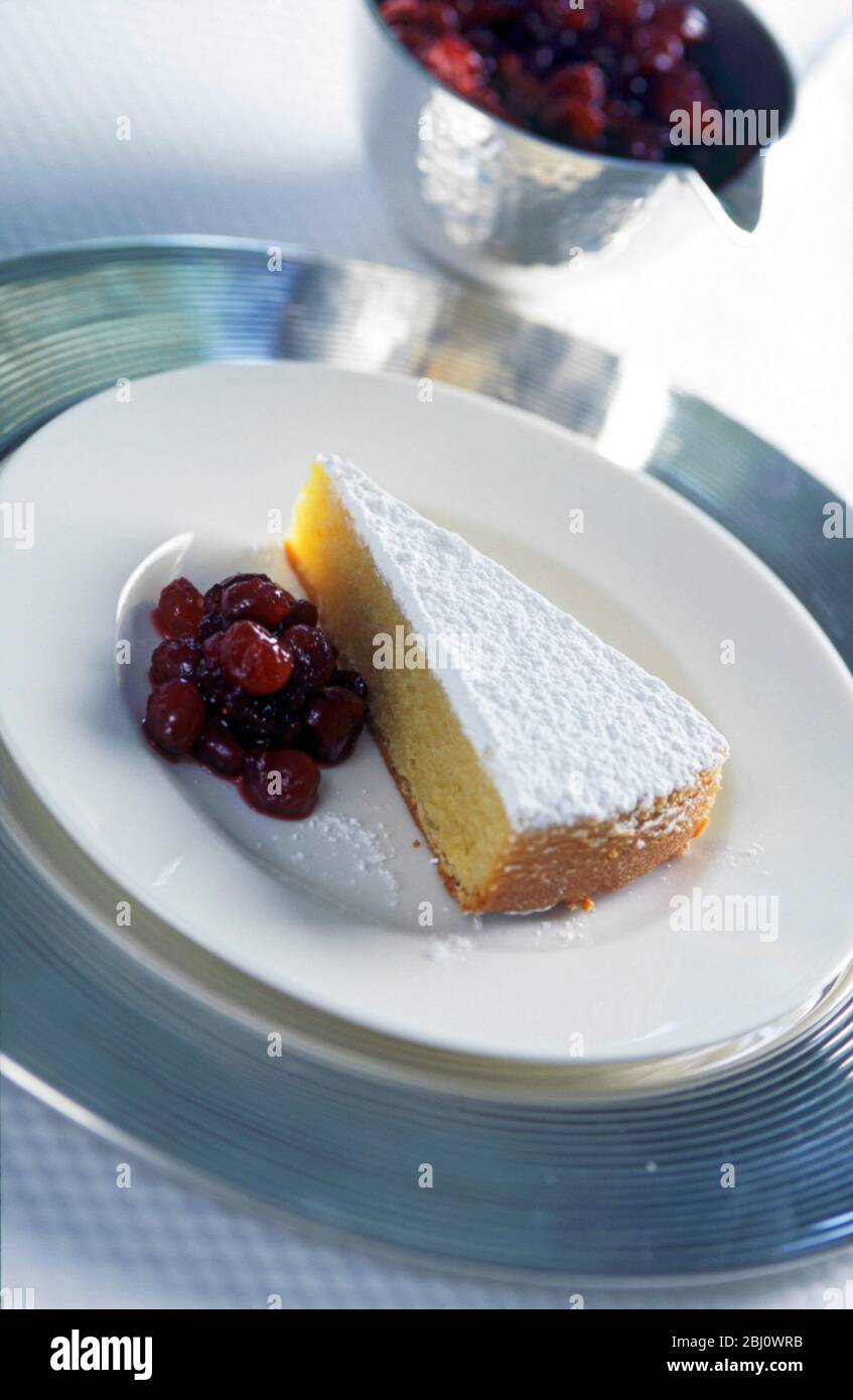 Moist dense sponge cake made with semolina served with cherry conserve - Stock Photo