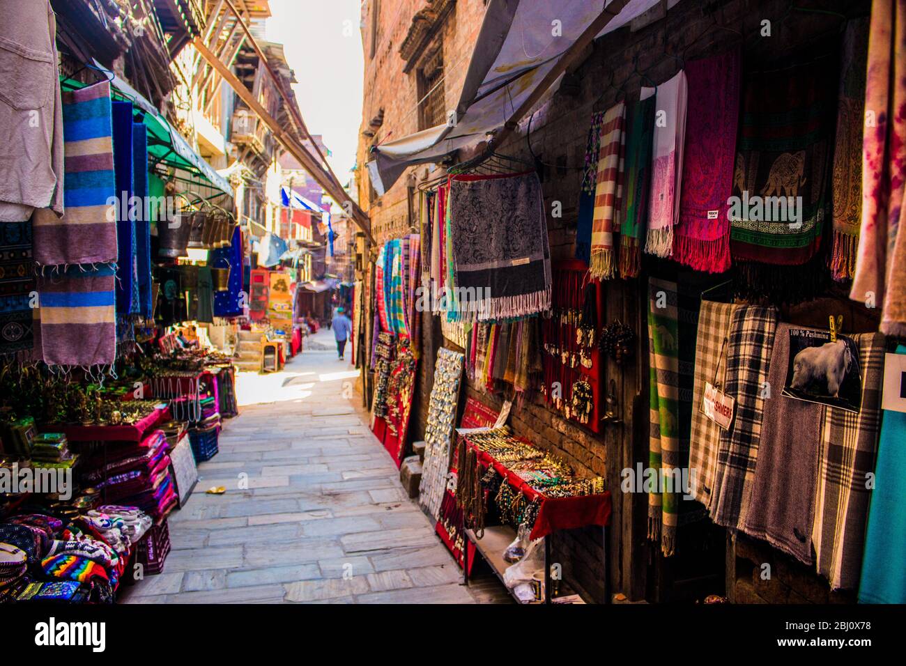 Market street shops, scarfs against Corona Virus, Bhaktapur, Nepal Stock Photo