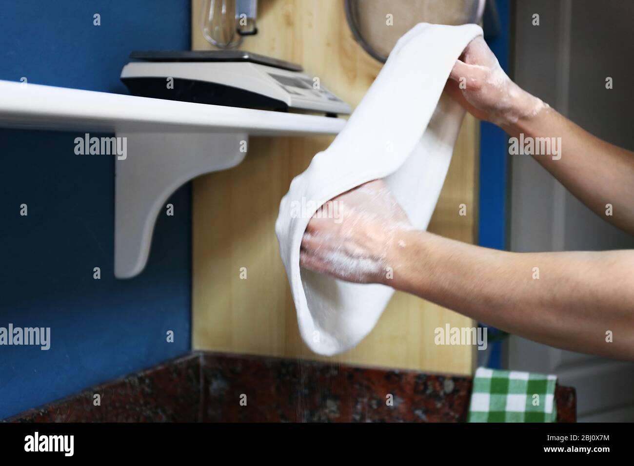 Chef preparing pizza dough on marble table, closeup Stock Photo