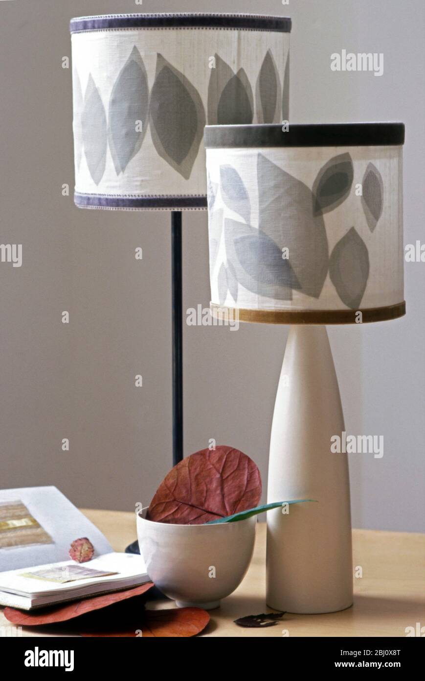 Modern lamps with shades made from layers of different coloured organza cut into leaf shapes in interior setting - Stock Photo