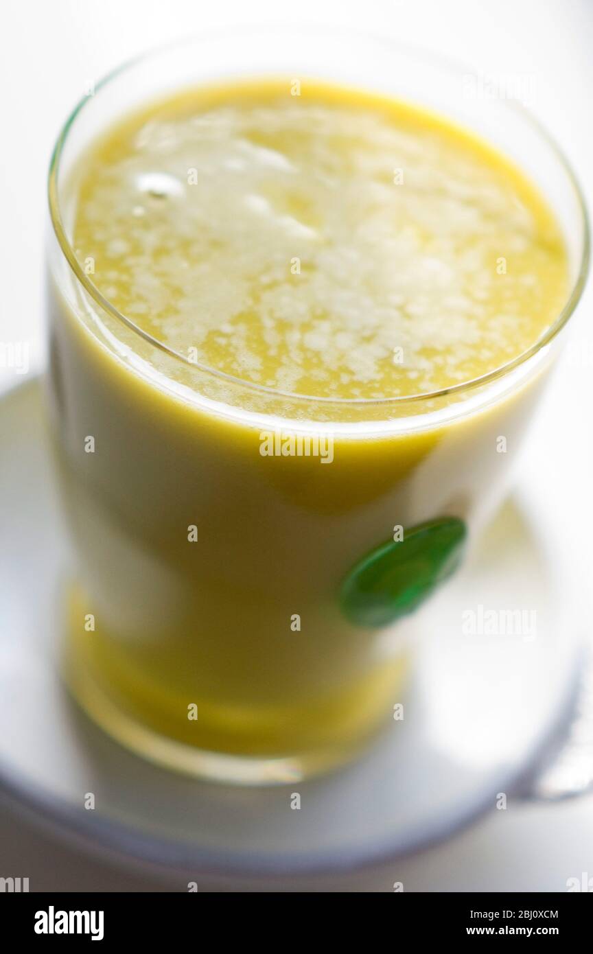 Smoothie made of kiwi fruit and orange juice blended with egg and honey