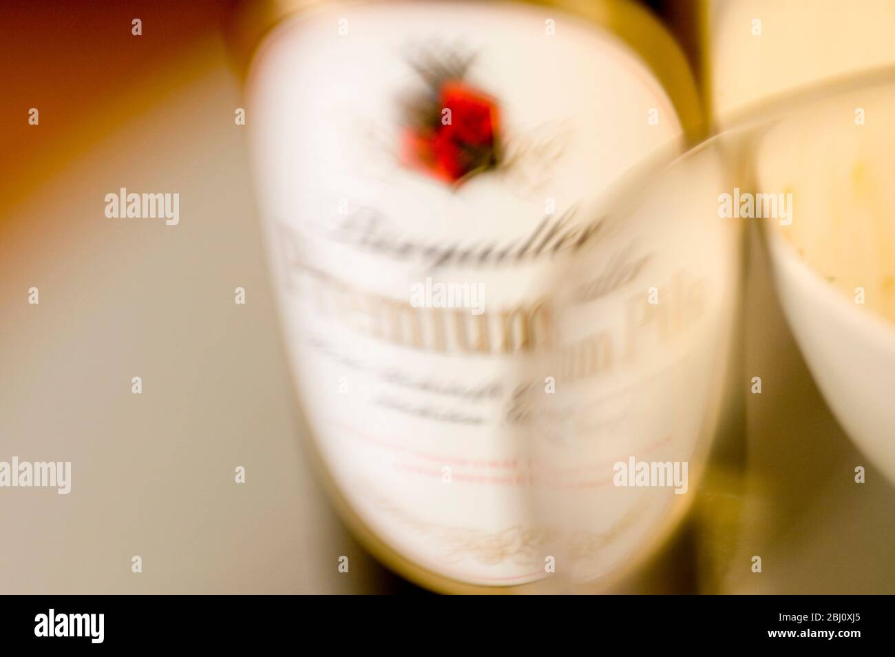Beer bottle label and rim of glass. Shot with lensbabies lens - Stock Photo
