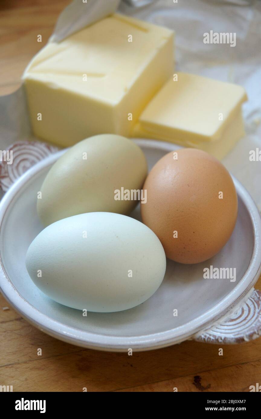 Getting out the ingredients to make a cake - using organic eggs. - Stock Photo