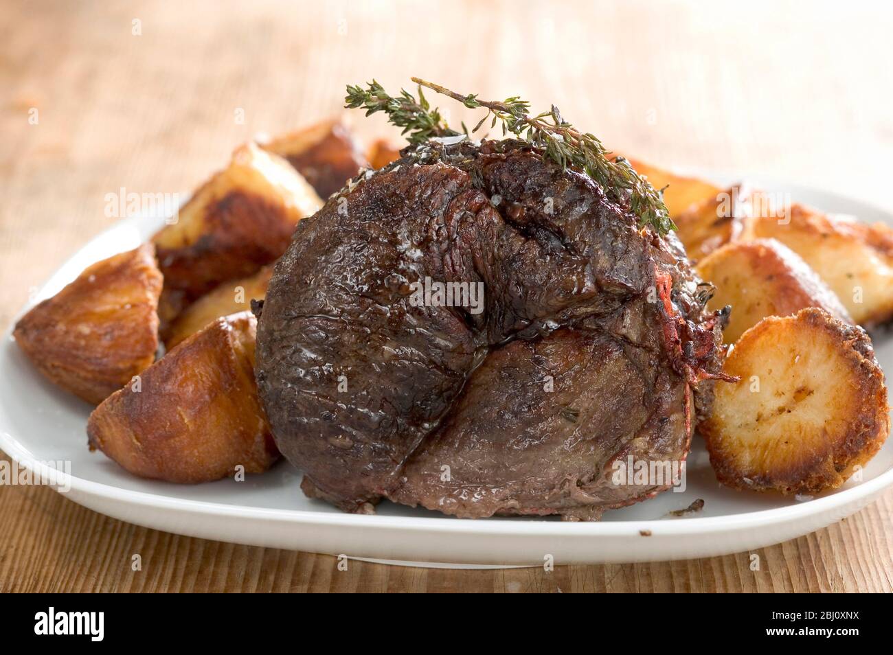 Traditional British sunday lunch of roast beef and roast potatoes - Stock Photo